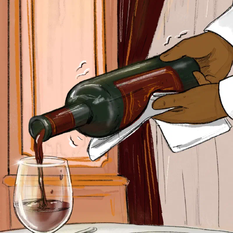 Hege shakingly pouring a glass of red wine from a bottle