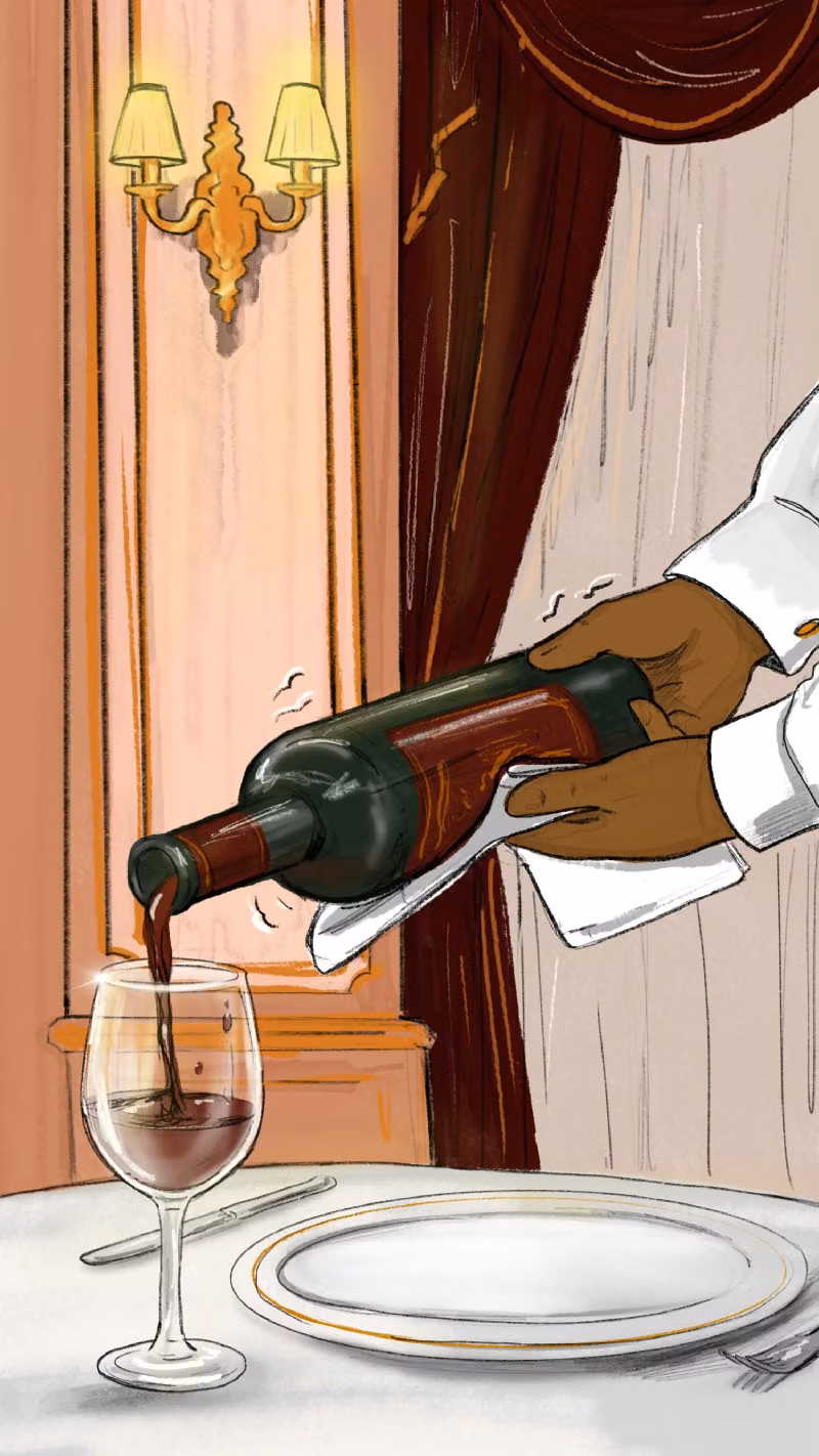 Hege pouring a bottle of wine in the Hegilton Restaurant
